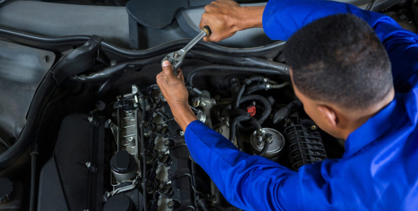 Mechanic conducting engine repairs